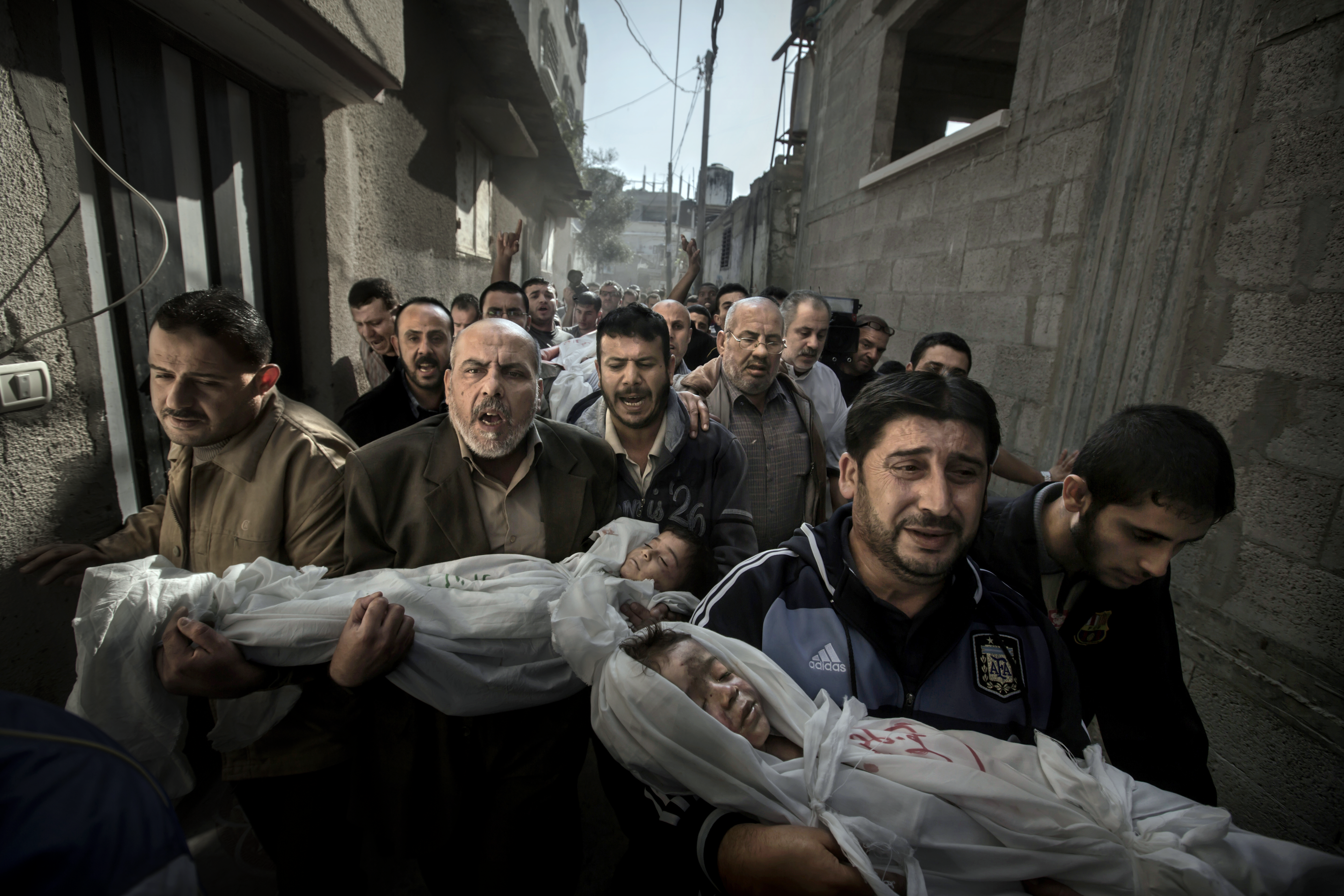Relatives carry two brothers killed when their Gaza home was bombed, during fighting between Israel and Palestinian armed groups involving rocket fire and airstrikes.